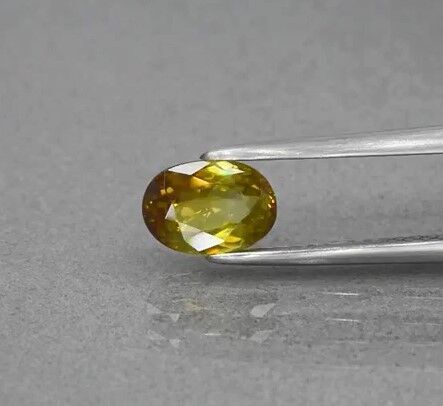 0.94ct 7x5mm VS Oval Natural Yellowish Green Sphene, Adamantine Luster